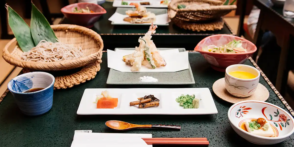 Traditional Japanese dinner with soba, tempura and small dishes